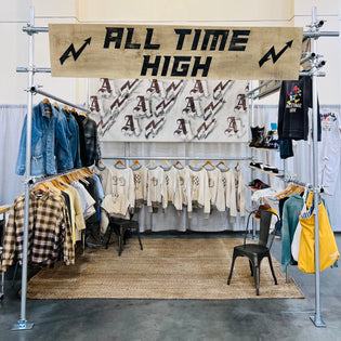 ATH booth with logo banner and display of clothing