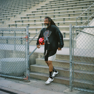  Wil stepping on to the field wearing ATH checkerboard football shorts logo slub knit long sleeve and adidas sambas