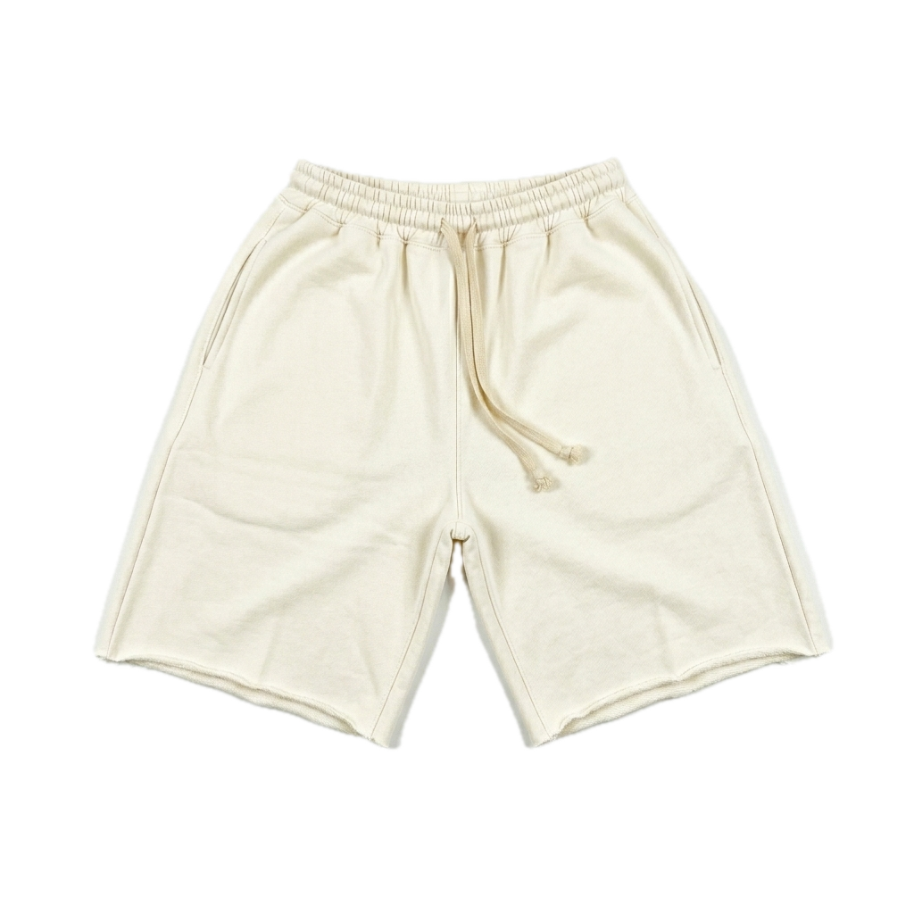 Cream-colored cotton sweat shorts with an elastic waistband and matching drawstring, laid flat on a white background.